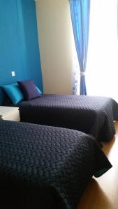 a bedroom with two beds and a window at Apartamento Anjos in Lisbon