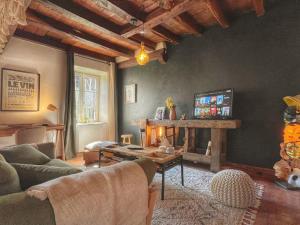 a living room with a couch and a table at La longère du Ruet in Saint-Hilaire-Saint-Mesmin +8 photos