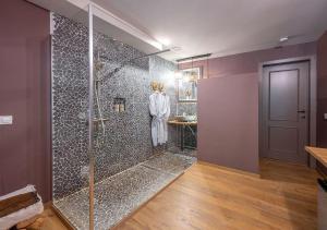 a bathroom with a walk in shower with a glass door at BRU-LAGOON Guesthouse in Bruges