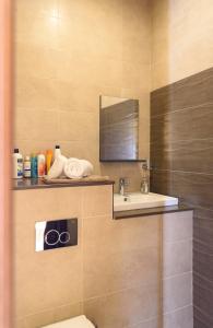 a bathroom with a sink and a toilet and a mirror at Casa Deguara townhouse Rabat Malta in Rabat