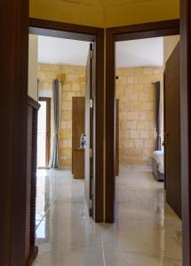 a hallway with two doors leading to a bedroom at Casa Deguara townhouse Rabat Malta in Rabat