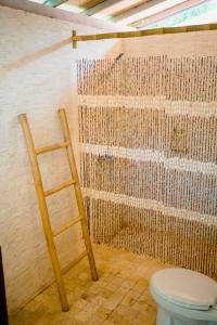 a bathroom with a ladder next to a toilet at BUNGALOW CAFE GILI BEACH FRONT in Gili Meno