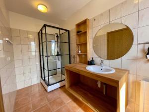 a bathroom with a sink and a mirror at Matkráin Apartments in Hveragerði