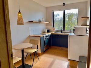 a small kitchen with a small table and a sink at Matkráin Apartments in Hveragerði