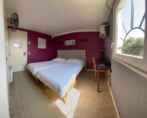 Ένα ή περισσότερα κρεβάτια σε δωμάτιο στο Contact Hotel LE SUD Montpellier Aéroport Parc Expo Arena
