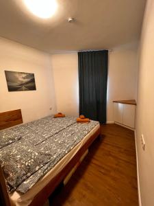 a bedroom with a bed and a window at Puzzle Haus in Gyenesdiás