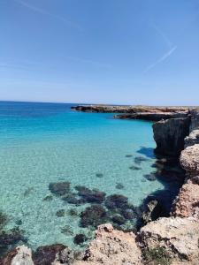 a view of the ocean from a rocky beach at Le casette in Monopoli