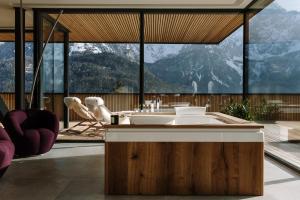 a bathroom with a tub with a view of mountains at Chalet Sofija in Gozd Martuljek