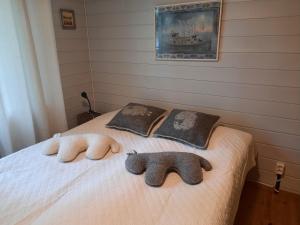 a bedroom with two stuffed animals on a bed at Luonnon rauhaa Kalliosaaressa, private island in Polvijärvi