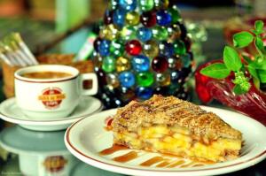 a piece of cake on a plate next to a cup of coffee at Pousada Ilha do Mel Café in Ilha do Mel