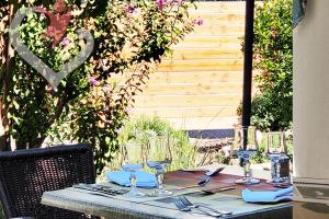 a table with glasses and napkins on top at HOTEL RESTAURANT OLYMPE in Aix-en-Provence +4 photos