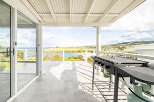 a balcony with a view of the ocean at Kiama Beach House & Private Beach & Newly Renovated in Kiama