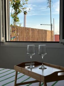 two wine glasses sitting on a table in front of a window at Eagle's Nest in Athens