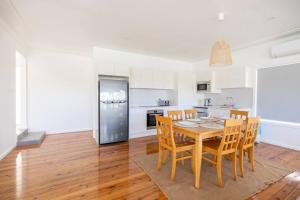 a kitchen and dining room with a table and chairs at Kiama Beach House & Private Beach & Newly Renovated in Kiama