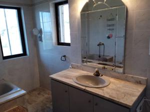 uma casa de banho com um lavatório e um espelho em Bill's Sea View em Aghia Marina