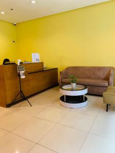 a waiting room with a couch and a table at Studio 8th FL with Balcony across Terminal 3 Airport in Manila