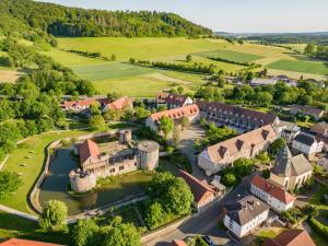 an aerial view of a town with a castle and a river at Göbels Schlosshotel "Prinz von Hessen" in Friedewald