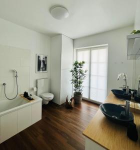 a bathroom with two sinks and a toilet at Apartment Leo6 in Salzburg