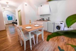 a kitchen and dining room with a table and chairs at Dragon's Cave in Ljubljana