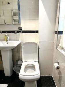 a small bathroom with a toilet and a sink at Comfortable Studio flat near Central London in London