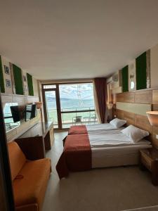 A bed or beds in a room at Briz Beach apartments - section B