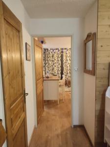 a hallway with a room with a desk and a door at Studio 4-6 couchages.pied des pistes.Résidence Montana1 in Les Deux Alpes