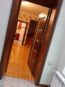 an empty hallway with a door and a wooden floor at My sweet home in Ramana in Baku