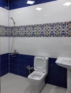 a blue and white bathroom with a toilet and a sink at My sweet home in Ramana in Baku