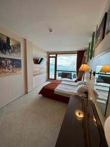 a bedroom with a bed and a large window at Briz Beach apartments - section B in Sunny Beach