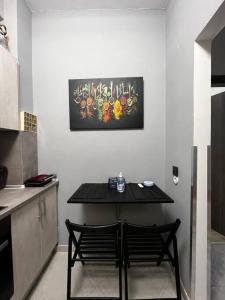 a kitchen with a black table and two chairs at Beautiful Apartment in Corfu in Agios Rokkos