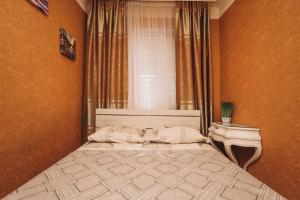 a bedroom with a large bed with a window at Квартира в центре города in Sumy