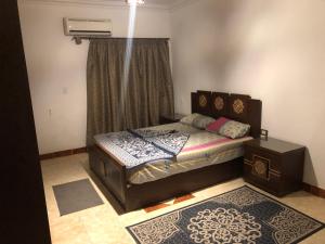 a small bedroom with a bed and a window at Three-Bedroom Apartment in Mohandseen in Cairo
