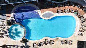 an overhead view of a swimming pool at a resort at Flipflop Cala Mandia in Cala Romàntica