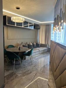 a living room with a couch and a table at Apart Elena Arcadia Sea View in Odesa