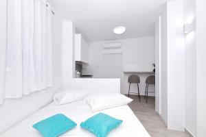 a white room with a bed with two pillows on it at Silver stars 1 in Zadar