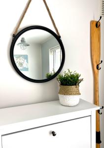 a mirror on top of a dresser at ‘The Loft’ - Apartment by the sea in Combe Martin