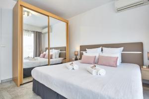 a bedroom with two beds and a large mirror at Cannes centre-Palais-200m des plages in Cannes