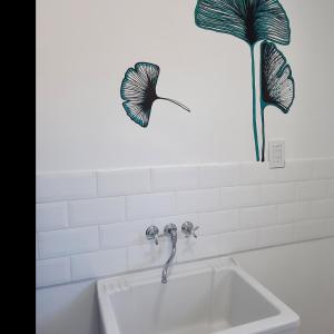 a sink in a bathroom with a plant on the wall at Lacus. Casas de lago. in Almafuerte