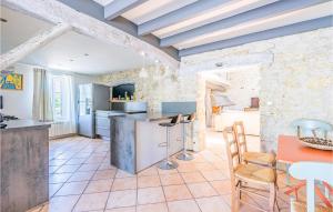 a kitchen and dining room with a stone wall at Nice Home In Mdis With Private Swimming Pool, Can Be Inside Or Outside in Médis