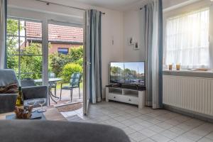 TV a/nebo společenská místnost v ubytování Ferienhaus 50007