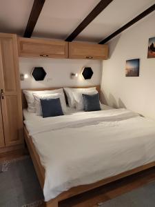 a large bed with white sheets and blue pillows at Relax green house in Rovinj