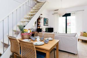 a dining room with a table and chairs at Oliva Holiday Homes in Dhiyeliótika
