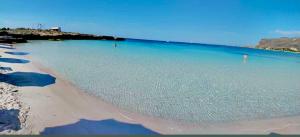 a beach with a large body of water at Stabilimento Lido Burrone in Favignana