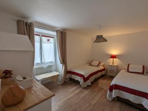 a small room with two beds and a window at La Métairie de la Pétillerie in Roullet-Saint-Estèphe