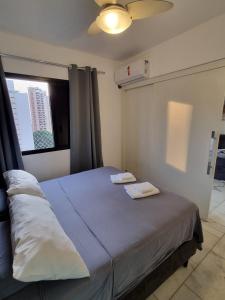 a bedroom with a bed with two towels on it at Port Dela Vilete in Sao Paulo