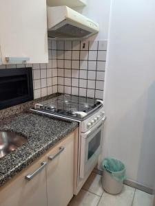 a kitchen with a stove and a sink at Port Dela Vilete in Sao Paulo