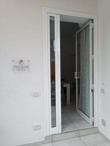 a sliding glass door leading into a room at Clio's House - Mondello in Mondello