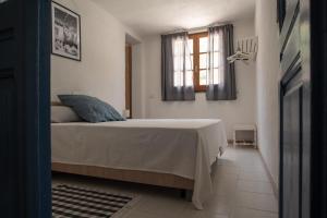 a bedroom with a bed and a window at Baccu Mandara Sea View Modern Villa with Parking! in Geremeas +54 photos