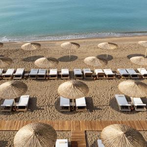an overhead view of a beach with chairs and umbrellas at Titanic Deluxe Lara in Lara