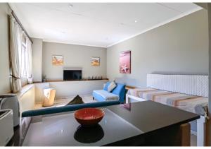 a living room with a couch and a table at Ballito Bay Holiday Apartment in Ballito